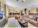 Open living room showcasing a cozy seating area and views into the kitchen at 1465 Belle Terre Rd, Davenport, FL 33896