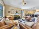 Open concept living room with comfortable seating and views of kitchen and backyard at 1465 Belle Terre Rd, Davenport, FL 33896