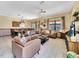 Spacious living room with leather furniture and large TV at 1465 Belle Terre Rd, Davenport, FL 33896
