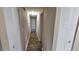 Long hallway with light walls and built-in storage at 3220 Chariot Pl, Orlando, FL 32818