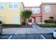 Two-story townhome with yellow and peach exterior at 904 Park Terrace Cir, Kissimmee, FL 34746