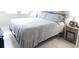 Spacious bedroom with gray bedding and nightstand at 5430 Nw 34Th St, Ocala, FL 34482