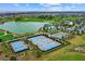Aerial view of community with lake and courts at 5430 Nw 34Th St, Ocala, FL 34482
