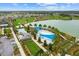 Aerial view of community pool, lake, and surrounding neighborhood at 5430 Nw 34Th St, Ocala, FL 34482