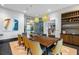 Elegant dining room with a large table, wine storage, and modern lighting at 5430 Nw 34Th St, Ocala, FL 34482