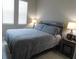 Bright bedroom with gray bedding and wooden headboard at 5430 Nw 34Th St, Ocala, FL 34482