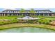 Resort-style clubhouse with outdoor seating and a pond at 5430 Nw 34Th St, Ocala, FL 34482