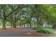 Paved walking trail winding through lush trees in a park-like setting at 5430 Nw 34Th St, Ocala, FL 34482