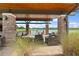 Brick-columned covered patio with wicker furniture overlooking the lake at 5430 Nw 34Th St, Ocala, FL 34482