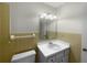 Bathroom with beige tile, vanity, and toilet at 46 Columbine Trl, Debary, FL 32713