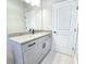 Bathroom with gray vanity, granite countertop, and a bathtub at 16973 Sw 39Th Cir, Ocala, FL 34473