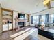 Spacious living room with fireplace, built-ins, and large windows at 202 Ellsworth Ct, Kissimmee, FL 34758
