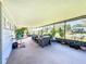 Screened porch with seating and numerous potted plants at 202 Ellsworth Ct, Kissimmee, FL 34758