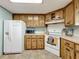 Kitchen with wood cabinets, a microwave, and a refrigerator at 202 Ellsworth Ct, Kissimmee, FL 34758