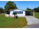 Single-wide manufactured home with carport and landscaped yard at 202 Ellsworth Ct, Kissimmee, FL 34758