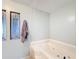 Bathroom with a jetted tub and stained glass window at 202 Ellsworth Ct, Kissimmee, FL 34758