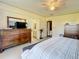 Main bedroom with king bed, dresser, and en-suite bathroom at 202 Ellsworth Ct, Kissimmee, FL 34758