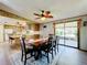 Open concept dining area with kitchen views and sliding doors to patio at 202 Ellsworth Ct, Kissimmee, FL 34758