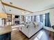Bright living room with hardwood floors, a fireplace, and large windows at 202 Ellsworth Ct, Kissimmee, FL 34758