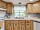 Kitchen with wood cabinets, a double sink, and a window at 202 Ellsworth Ct, Kissimmee, FL 34758