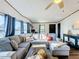 Cozy living room featuring a spacious sectional sofa and a large window at 202 Ellsworth Ct, Kissimmee, FL 34758
