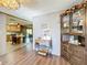Bright dining room with wood-look flooring and built-in hutch at 202 Ellsworth Ct, Kissimmee, FL 34758