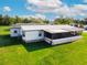 Single wide home with large yard and screened porch at 202 Ellsworth Ct, Kissimmee, FL 34758