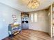 Dining room with wood-look flooring, corner cabinet, and stained glass at 202 Ellsworth Ct, Kissimmee, FL 34758