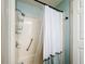 Shower stall with a white curtain and storage at 202 Ellsworth Ct, Kissimmee, FL 34758