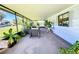 Covered porch with seating area and tropical plants at 202 Ellsworth Ct, Kissimmee, FL 34758
