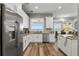 Bright kitchen featuring white cabinets, stainless steel appliances, and lake view at 6019 Linneal Beach Dr, Apopka, FL 32703