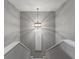 Elegant staircase with modern light fixture and wall art at 6019 Linneal Beach Dr, Apopka, FL 32703