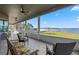 Large screened porch overlooking the lake with seating at 6019 Linneal Beach Dr, Apopka, FL 32703