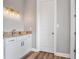 Small bathroom with granite countertop and white cabinets at 6019 Linneal Beach Dr, Apopka, FL 32703
