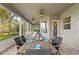 Screened patio with outdoor dining table and lake views at 6019 Linneal Beach Dr, Apopka, FL 32703
