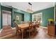 Elegant dining room with teal walls and a large wooden table at 6019 Linneal Beach Dr, Apopka, FL 32703