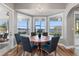 Bright dining room with lake view and wooden table for six at 6019 Linneal Beach Dr, Apopka, FL 32703