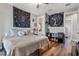 Bedroom with king-size bed, wood floors, and unique wall decor at 6019 Linneal Beach Dr, Apopka, FL 32703