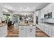 Modern kitchen with white cabinets, granite island, and stainless steel appliances at 6019 Linneal Beach Dr, Apopka, FL 32703