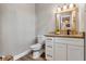 Powder room with granite countertop and white cabinets at 6019 Linneal Beach Dr, Apopka, FL 32703