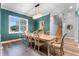 Formal dining room with teal walls, wood table and eight chairs at 6019 Linneal Beach Dr, Apopka, FL 32703