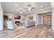 Spacious living room featuring hardwood floors, fireplace, and large TV at 6019 Linneal Beach Dr, Apopka, FL 32703