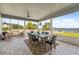 Spacious screened porch with lake view, dining table, and wicker chairs at 6019 Linneal Beach Dr, Apopka, FL 32703