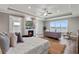 Luxurious main bedroom with fireplace, sitting area, and lake views at 6019 Linneal Beach Dr, Apopka, FL 32703