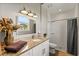 Bathroom with granite countertop, white cabinets, and shower at 6019 Linneal Beach Dr, Apopka, FL 32703