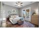 Main bedroom with king bed, access to a private balcony, and water views at 6019 Linneal Beach Dr, Apopka, FL 32703