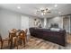 Relaxing living room featuring a brown leather sectional sofa and game table at 6019 Linneal Beach Dr, Apopka, FL 32703