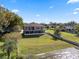 Backyard view of a house with a large lot and lake access at 6019 Linneal Beach Dr, Apopka, FL 32703