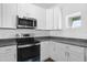 Modern kitchen with stainless steel appliances and granite countertops at 454 Lake Shore Pkwy, Davenport, FL 33896