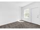 Cozy bedroom with carpet flooring, window, and exterior access at 454 Lake Shore Pkwy, Davenport, FL 33896